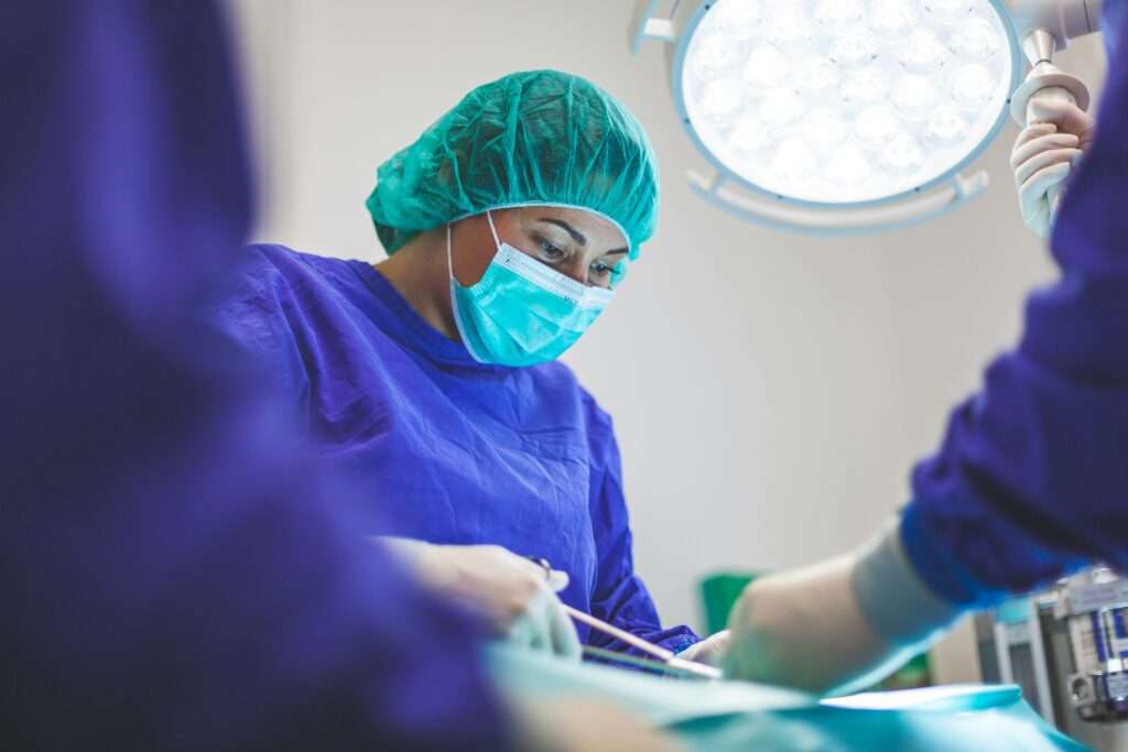 woman surgeon with blue mask