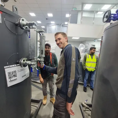 Trainee smiling during hands-on boiler valve training